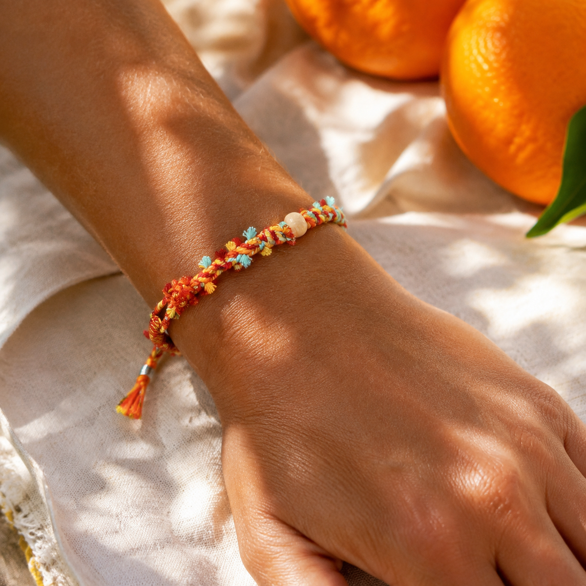 AI-generated styling illustration of the Apricot Breeze orange, yellow and mint bracelet worn on a wrist.