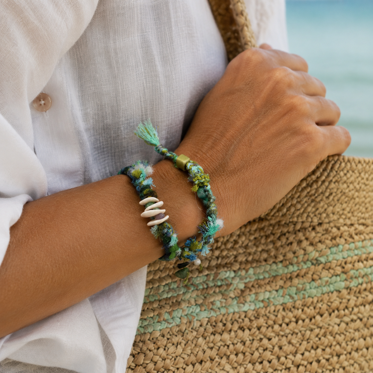 AI-generated styling illustration of the Seafoam teal, green and blue bracelet worn on a wrist.