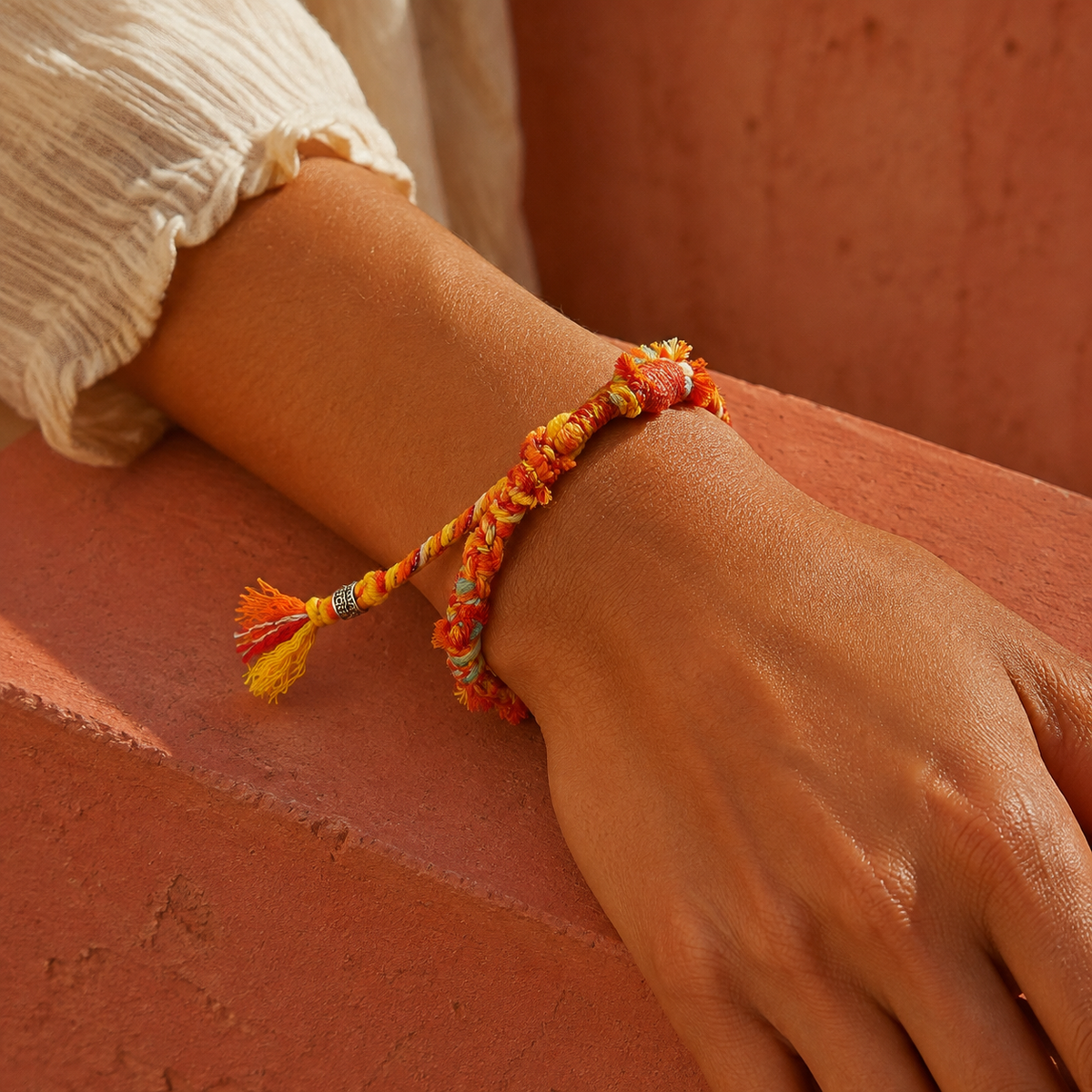 AI-generated styling illustration of the Sundrift orange, yellow and pale turquoise bracelet worn on a wrist.