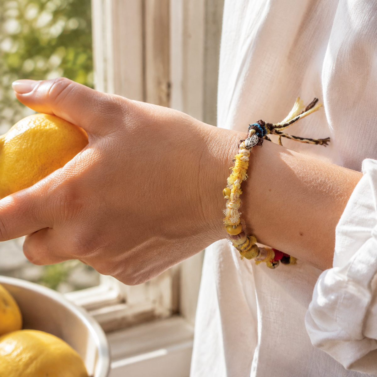 AI-generated styling illustration of the Sunlit Dune yellow, cream and brown bracelet worn on a wrist.