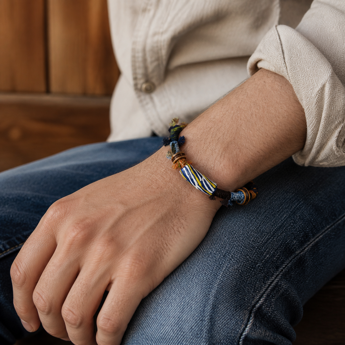 AI-generated styling illustration of the Tidal Line navy, brown and yellow bracelet worn on a wrist.