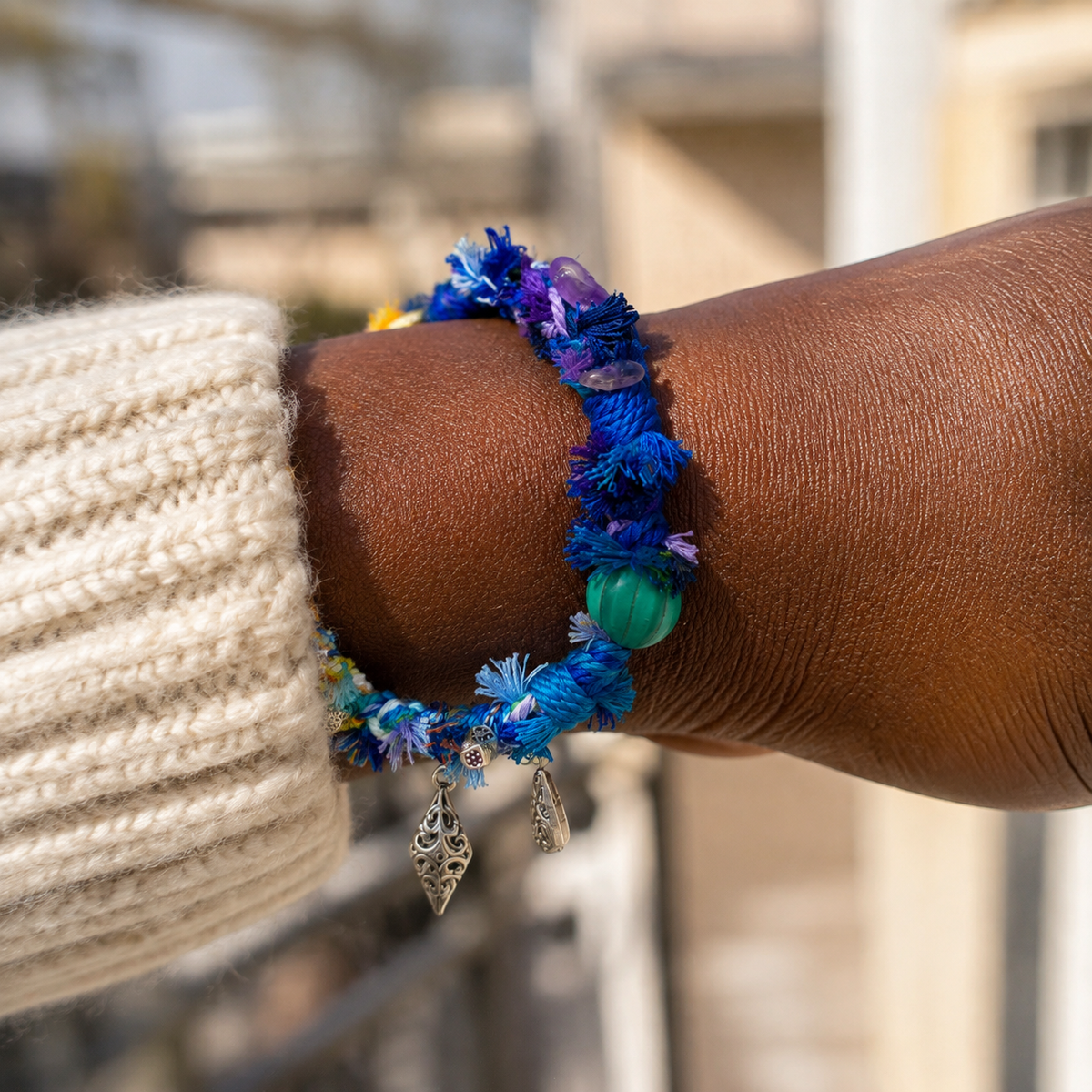 AI-generated styling illustration of the Twilight Tide blue, violet and yellow bracelet worn on a wrist.