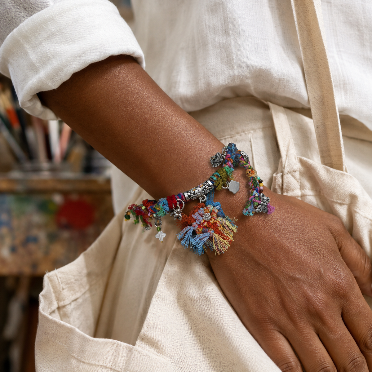 AI-generated styling illustration of the Wildflower Drift blue, pink, green and red bracelet worn on a wrist.